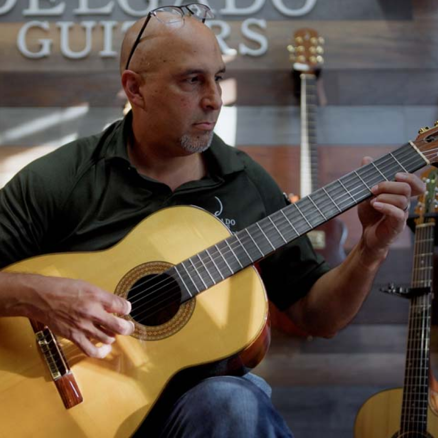 Delgado Guitars staff member playing guitar
