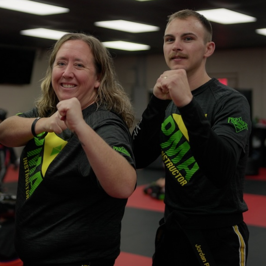 Instructors at Premiere Martial Arts pose in a fighting stance