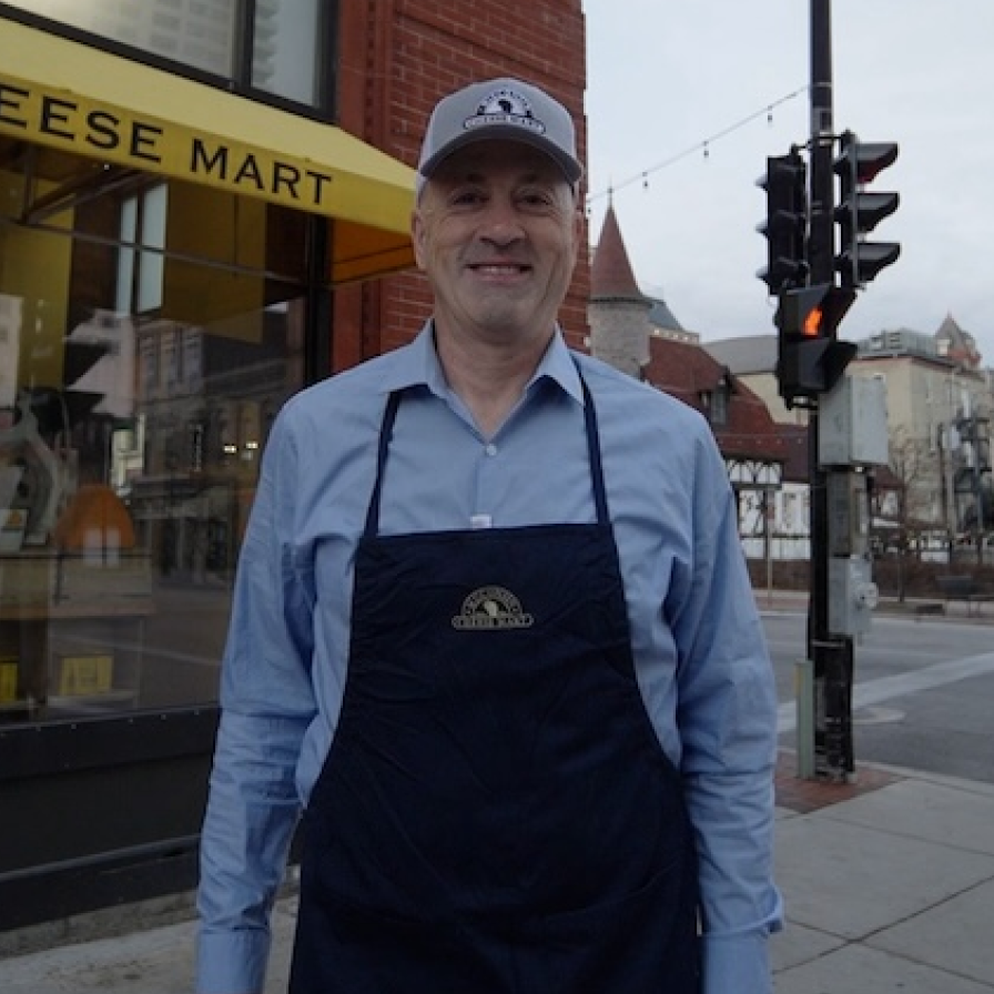 A Wisconsin Cheese Mart staff member standing outside the store