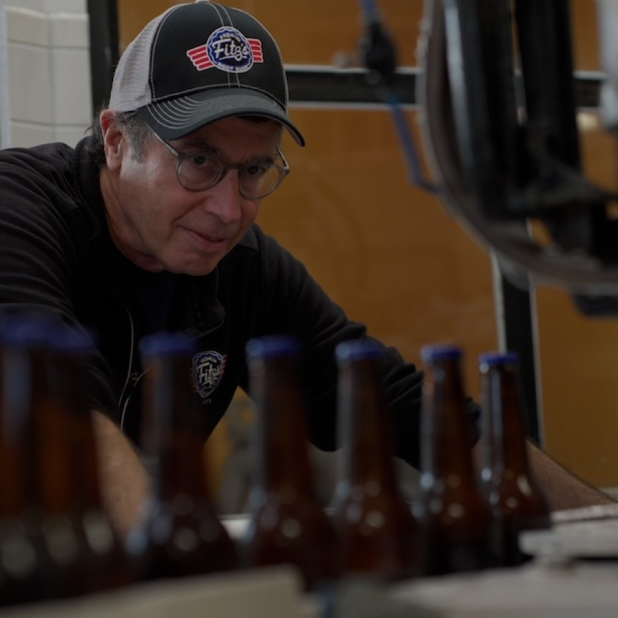 Fitz's Bottling Company employee with bottling machine

