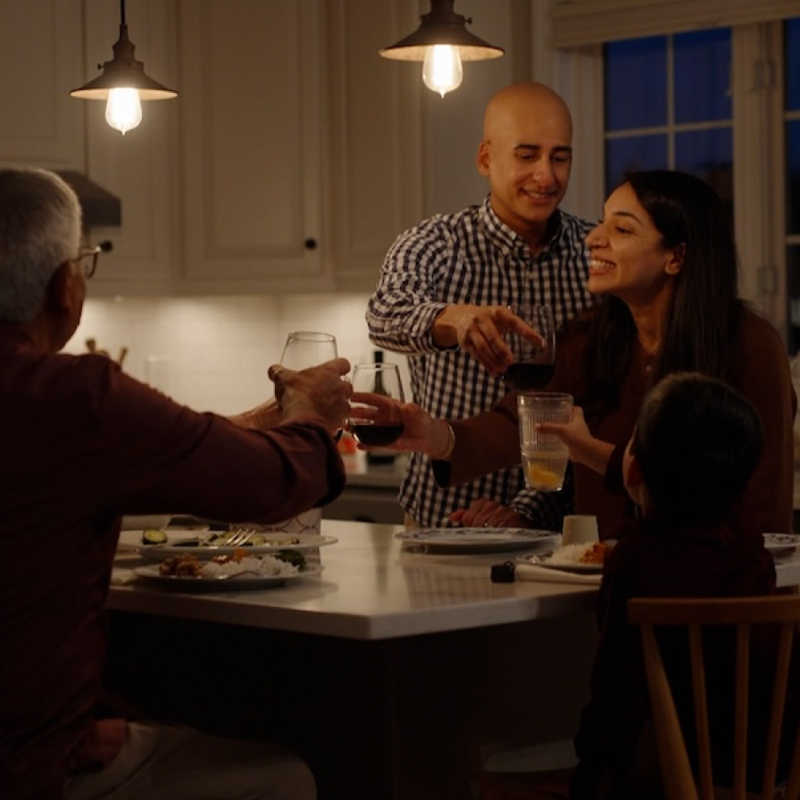 Down the Road Spice Co family share a meal in the kitchen
