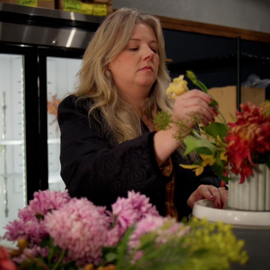 Sweet Talk Floral staff member arranging flowers