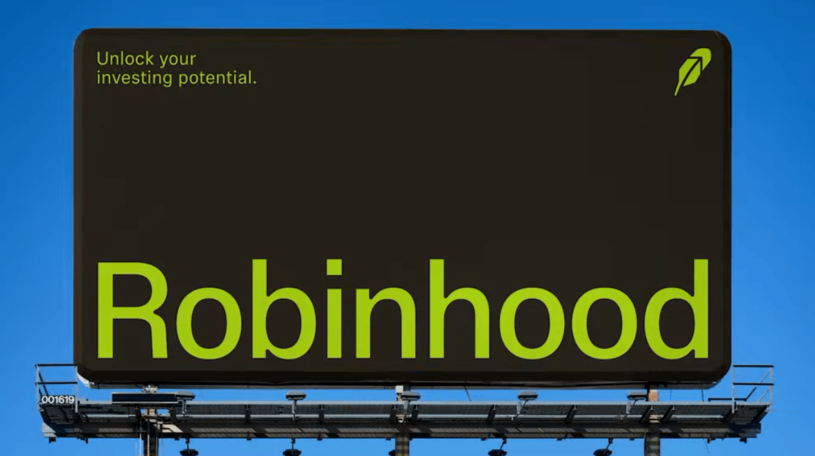 A black billboard against a blue sky displays the text "Unlock your investing potential.", along with the Robinhood logo.