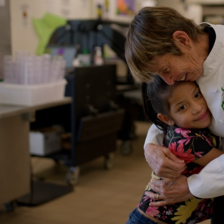 Chef Ann Foundation chef hugs a child