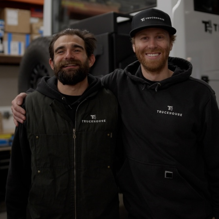 Two Truckhouse Nevada staff members in front of a vehicle