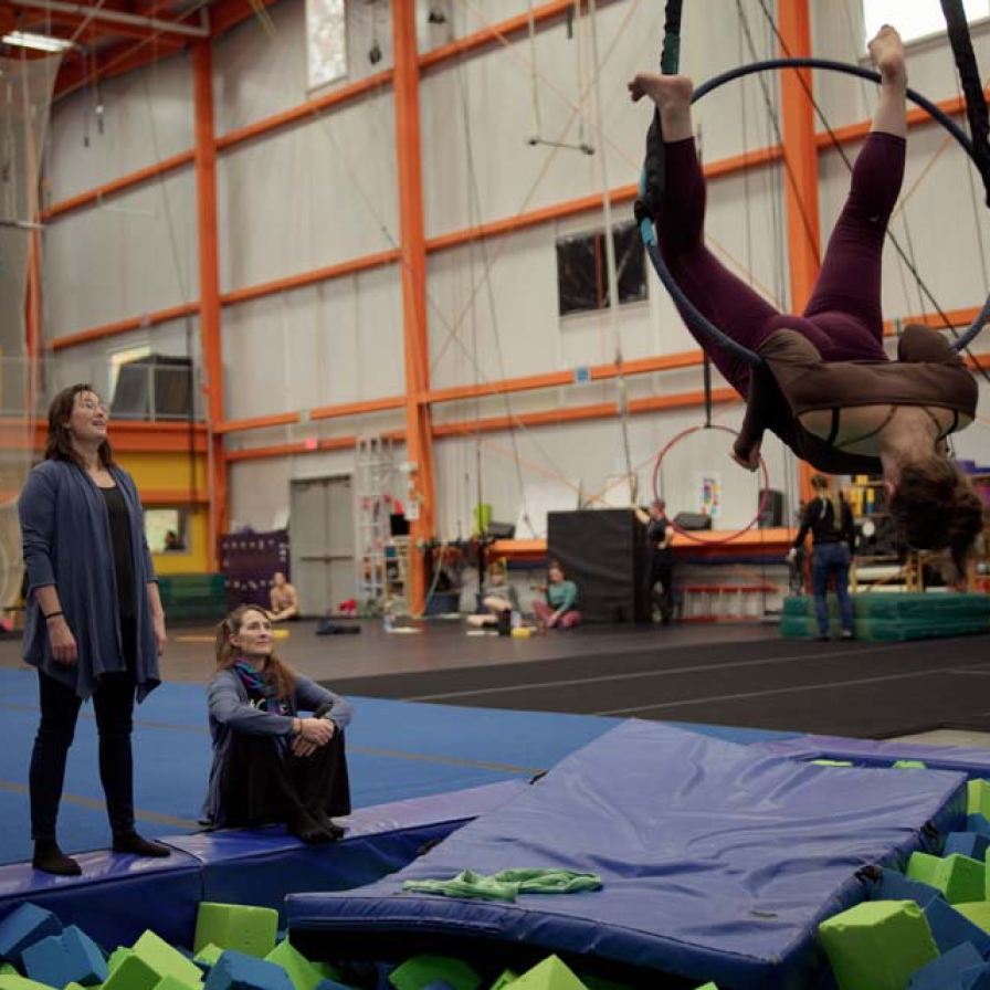 NE Center for the Circus Arts staff watch a performer in an aerial move